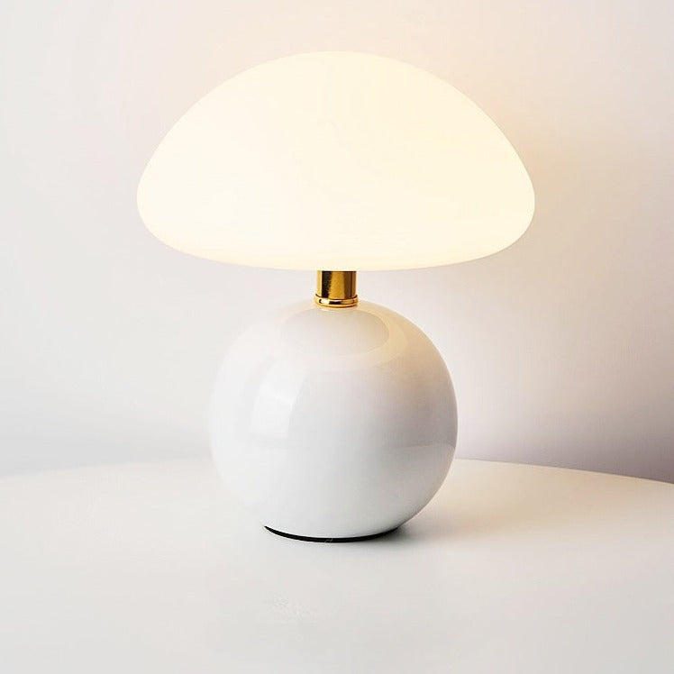 Ceramic table lamp with mushroom shape and LED light for cozy ambiance.