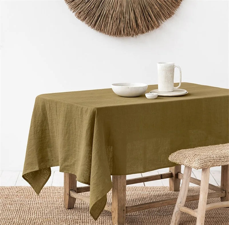 Rectangle tablecloth in turmeric color on a dining table, made of 100% pure linen.