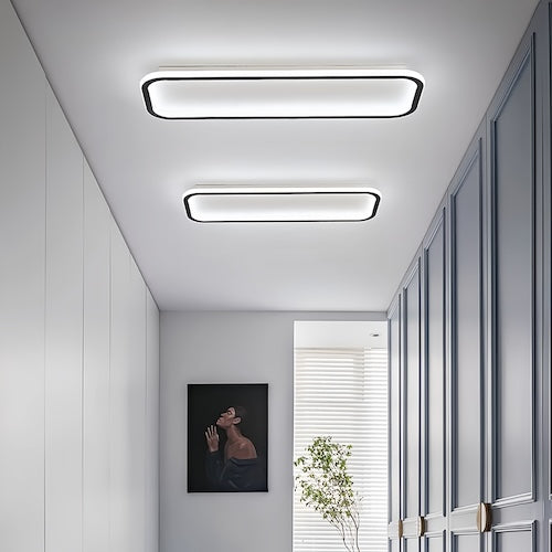 Modern LED ceiling lights in a minimalist hallway setting.