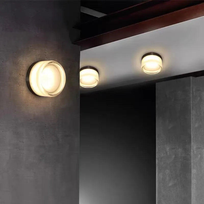 Wall sconce lighting with warm white illumination, acrylic shade, and sleek design. Suitable for kitchens, bathrooms, and cafes.