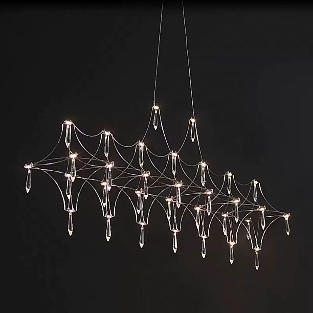 Modern chandelier with a spider web design on a black background