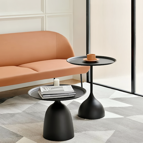 Contemporary round side tables in black metal, tall and short options, modern living room decor.