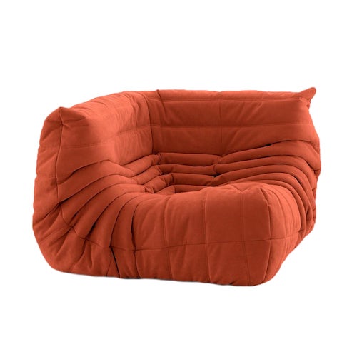 Ligne Roset Togo sofa in orange suede, showcasing a plush, curved design for modern comfort and style.