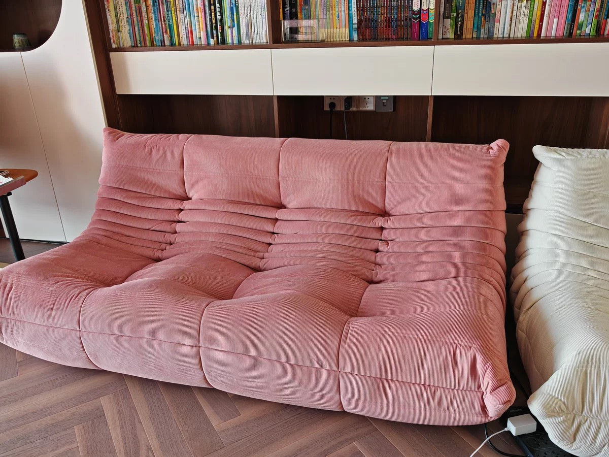 Pink Togo couch in corduroy fabric, perfect for stylish living spaces.