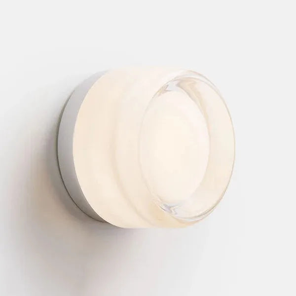 Wall sconce lighting with warm white light and acrylic shade.